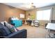 Versatile room featuring a sofa, craft tables, colorful accents, and a ceiling fan at 16626 W Baden Ave, Goodyear, AZ 85338