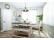 Cozy dining area features a modern light fixture, a farm style dining table and bench style seating at 16626 W Baden Ave, Goodyear, AZ 85338