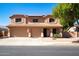 Two-story home featuring a tile roof, three-car garage, manicured landscaping and solar panels at 16626 W Baden Ave, Goodyear, AZ 85338