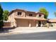 Two story home with three car garage, front yard landscaping, desert fauna and solar panels at 16626 W Baden Ave, Goodyear, AZ 85338