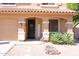 Inviting front entrance with decorative wreath, ample lighting, tasteful landscaping and a three car garage at 16626 W Baden Ave, Goodyear, AZ 85338