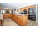 Spacious kitchen features wood cabinets, granite countertops, stainless steel appliances, and center island at 16626 W Baden Ave, Goodyear, AZ 85338