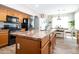 Kitchen features wood cabinets, granite countertops, stainless steel appliances, and eat in dining area at 16626 W Baden Ave, Goodyear, AZ 85338