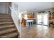 Open floor plan from stairs to kitchen with modern appliances, granite countertops, and tile flooring at 16626 W Baden Ave, Goodyear, AZ 85338