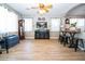 Spacious living room with wood floors, ceiling fan, and large windows at 16626 W Baden Ave, Goodyear, AZ 85338