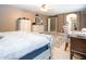 Neutral main bedroom boasts a ceiling fan, white furniture, and a decorative area rug at 16626 W Baden Ave, Goodyear, AZ 85338
