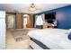 Main bedroom features a unique blue accent wall, ceiling fan, and access to the bathroom at 16626 W Baden Ave, Goodyear, AZ 85338