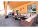 Relaxing covered patio with wicker furniture, a ceiling fan, and tiled flooring at 16626 W Baden Ave, Goodyear, AZ 85338