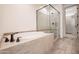 Luxurious bathroom with soaking tub and separate glass shower at 16868 W Earll Dr, Goodyear, AZ 85395