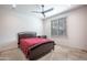 Cozy bedroom featuring a bed, side table, and window at 16868 W Earll Dr, Goodyear, AZ 85395