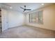 Spacious bedroom with large window, plantation shutters, neutral carpet, and recessed lighting at 16868 W Earll Dr, Goodyear, AZ 85395