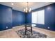 Charming dining room with bright blue walls, a glass table, and lots of natural light at 16868 W Earll Dr, Goodyear, AZ 85395