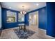 Bright dining room with vibrant blue walls and an open view into the entryway and other spaces at 16868 W Earll Dr, Goodyear, AZ 85395