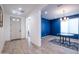 Inviting entryway with light wood floors leads to a dining room featuring a bold blue accent wall at 16868 W Earll Dr, Goodyear, AZ 85395