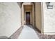 Close-up of a charming front door, framed by a stone archway and accented with decorative gravel at 16868 W Earll Dr, Goodyear, AZ 85395