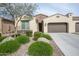 Charming single-story home featuring a well-manicured front yard with desert landscaping and a two-car garage at 16868 W Earll Dr, Goodyear, AZ 85395