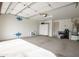 Spacious two car garage with white walls, storage cabinets, and garage door at 16868 W Earll Dr, Goodyear, AZ 85395
