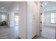 Hallway with white cabinets leading to rooms with natural light and neutral tones at 16868 W Earll Dr, Goodyear, AZ 85395