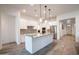 Modern kitchen featuring a center island, granite countertops, stainless steel appliances, and white cabinetry at 16868 W Earll Dr, Goodyear, AZ 85395