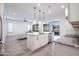 Bright, modern kitchen with stainless steel appliances, granite countertops, island, and easy access to living spaces at 16868 W Earll Dr, Goodyear, AZ 85395