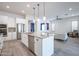 Bright kitchen featuring a spacious island, granite countertops, stainless steel appliances and an open layout at 16868 W Earll Dr, Goodyear, AZ 85395