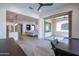 Open-concept living and dining area with stainless appliances and access to an outdoor patio space at 16868 W Earll Dr, Goodyear, AZ 85395