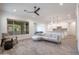 Bright, open living room with a comfortable seating arrangement leading to the modern kitchen area at 16868 W Earll Dr, Goodyear, AZ 85395