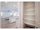 Well-organized, walk-in pantry with multiple shelves for optimal storage adjacent to the kitchen at 16868 W Earll Dr, Goodyear, AZ 85395