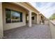 Covered patio with brick flooring, showcasing an ideal outdoor living space at 16868 W Earll Dr, Goodyear, AZ 85395