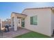 Backyard featuring a covered patio, well-maintained pavers, and a patch of artificial turf, perfect for outdoor relaxation at 17342 W Patrick Ln, Surprise, AZ 85387