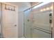 Bright bathroom featuring a glass-enclosed shower, white tiles, and modern fixtures, offering a clean and refreshing space at 17342 W Patrick Ln, Surprise, AZ 85387
