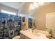 Well-lit bathroom with deer-themed shower curtain, single sink vanity and neutral decor at 17342 W Patrick Ln, Surprise, AZ 85387