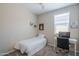 Bedroom featuring a bed, desk, and window with blinds, perfect for relaxation or studying at 17342 W Patrick Ln, Surprise, AZ 85387