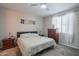 Calm bedroom featuring neutral walls, a ceiling fan, carpeted floors, and natural light, perfect for relaxation at 17342 W Patrick Ln, Surprise, AZ 85387