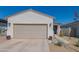 Charming single-story home featuring a neutral color scheme, two car garage, and a well-manicured front yard at 17342 W Patrick Ln, Surprise, AZ 85387