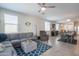 Spacious living area featuring a large sectional, dining set, and an open kitchen concept perfect for gatherings at 17342 W Patrick Ln, Surprise, AZ 85387