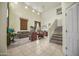 Bright and airy living room with soaring ceilings, tile entry, and a view of the staircase and dining area at 18037 N 14Th Pl, Phoenix, AZ 85022