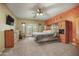 A large primary bedroom with a ceiling fan and doors to the outdoors at 18037 N 14Th Pl, Phoenix, AZ 85022