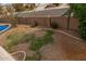 Aerial view of a backyard featuring decorative rock, partial grass coverage, and a view of neighboring homes at 1917 S Rock Ct, Gilbert, AZ 85295