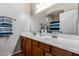 This bathroom has a double sink vanity with wooden cabinetry and a large mirror at 1917 S Rock Ct, Gilbert, AZ 85295