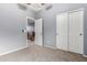 An empty bedroom with neutral carpet, dual closets, and an adjacent room is bright and airy at 1917 S Rock Ct, Gilbert, AZ 85295