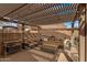 Relaxing covered patio featuring comfortable seating, ideal for enjoying the outdoors in a shaded and stylish setting at 1917 S Rock Ct, Gilbert, AZ 85295