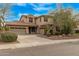 Inviting home showcasing a three-car garage, mature landscaping, and well-kept yard at 1917 S Rock Ct, Gilbert, AZ 85295