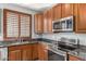 Beautiful kitchen featuring granite countertops, stainless steel appliances, and ample cabinet space at 1917 S Rock Ct, Gilbert, AZ 85295