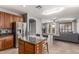 Open-concept kitchen with granite island, stainless steel appliances, seamlessly flowing into the cozy living space at 1917 S Rock Ct, Gilbert, AZ 85295