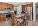 Modern kitchen features stainless appliances, granite countertops, and center island with a breakfast bar at 1917 S Rock Ct, Gilbert, AZ 85295