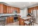 Modern kitchen features stainless appliances, granite countertops, and center island with a breakfast bar at 1917 S Rock Ct, Gilbert, AZ 85295