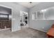 Open living room with carpeting that leads to another bedroom on the other side at 1917 S Rock Ct, Gilbert, AZ 85295