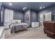 Spacious, carpeted main bedroom featuring a queen-size bed, two bedside tables, and a dresser at 1917 S Rock Ct, Gilbert, AZ 85295