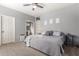 Main bedroom showing neutral decor, carpet, fan, walk in closet and ensuite bath at 1917 S Rock Ct, Gilbert, AZ 85295